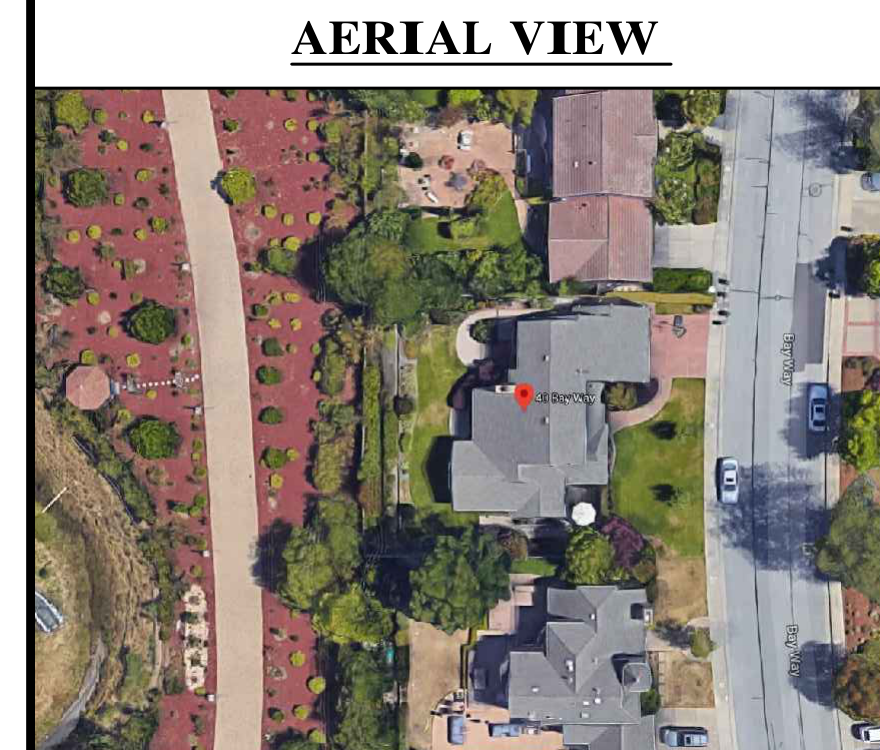 Aerial photograph of the residence and surrounding property showing the driveway and street.