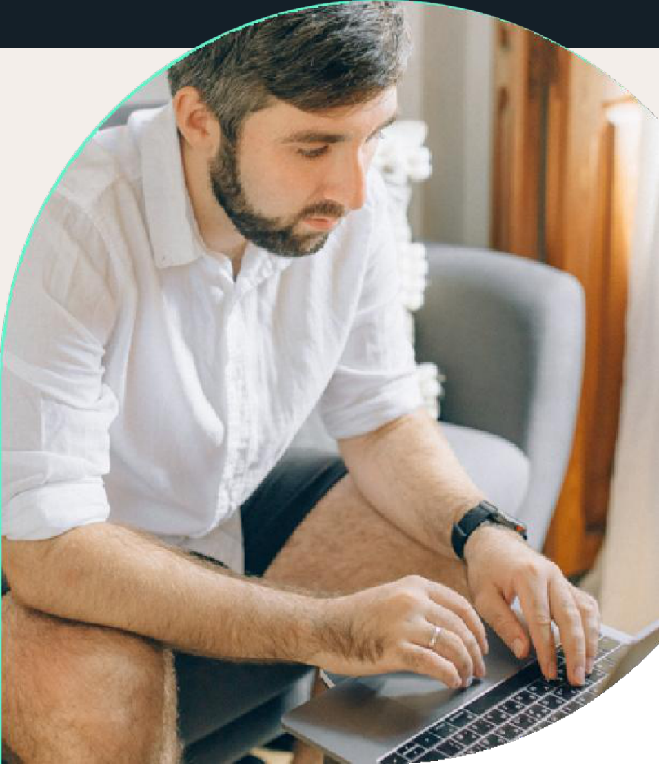 Man sitting comfortably and using a laptop