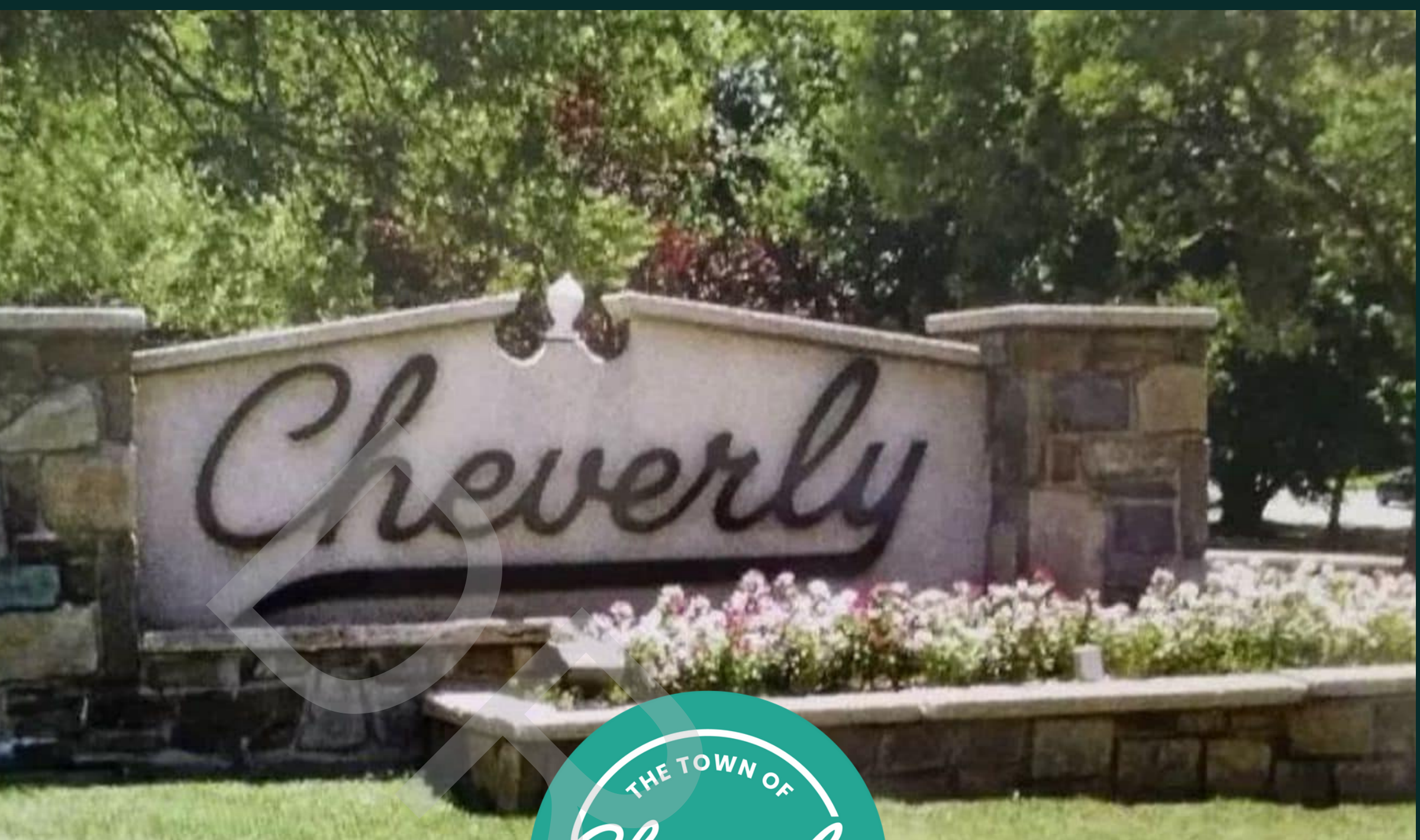 Cheverly entrance monument sign with landscaped flower bed and lush green trees