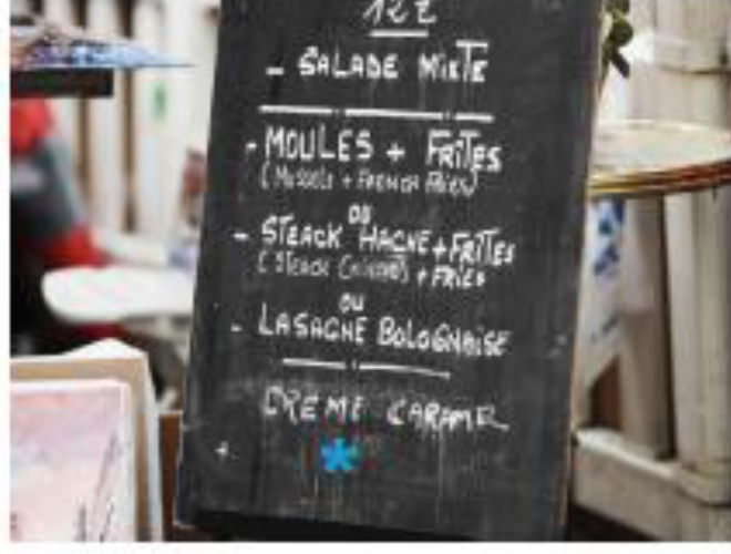 Example of an allergen statement indicated by an asterisk on a chalkboard bistro menu