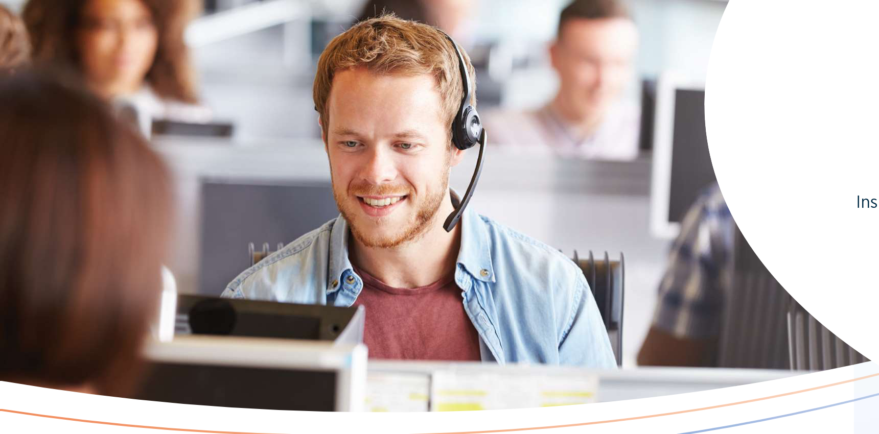 Healthcare advocate with headset smiling at desk in office