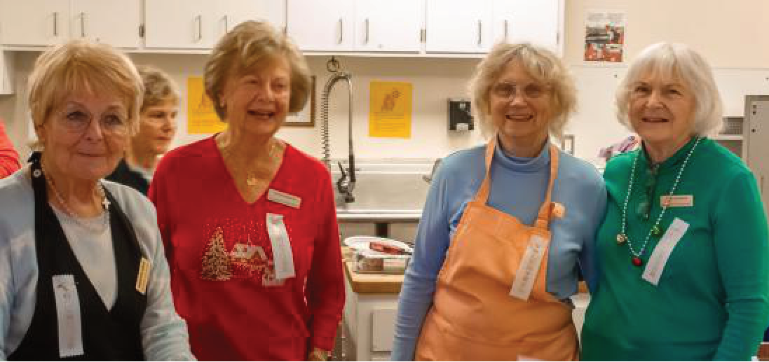 Four senior women smiling at a community event