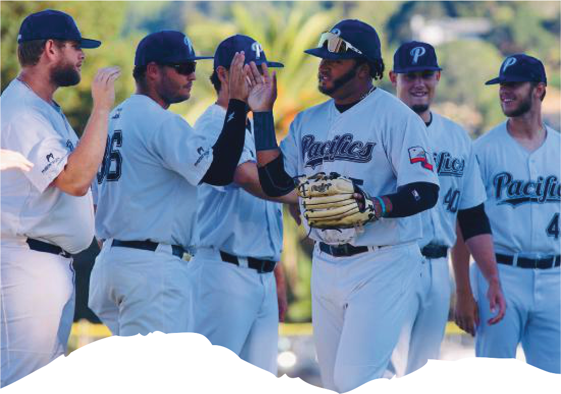 Group of San Rafael Pacifics baseball players high-fiving on the field.