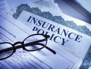 Insurance Policy document with glasses placed on top