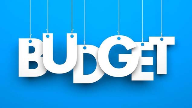 Hanging paper letters spelling BUDGET against a blue background