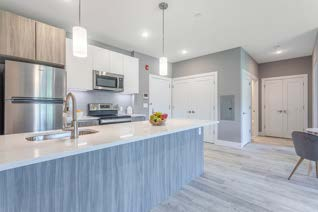 Interior view of apartment kitchen with modern island and appliances