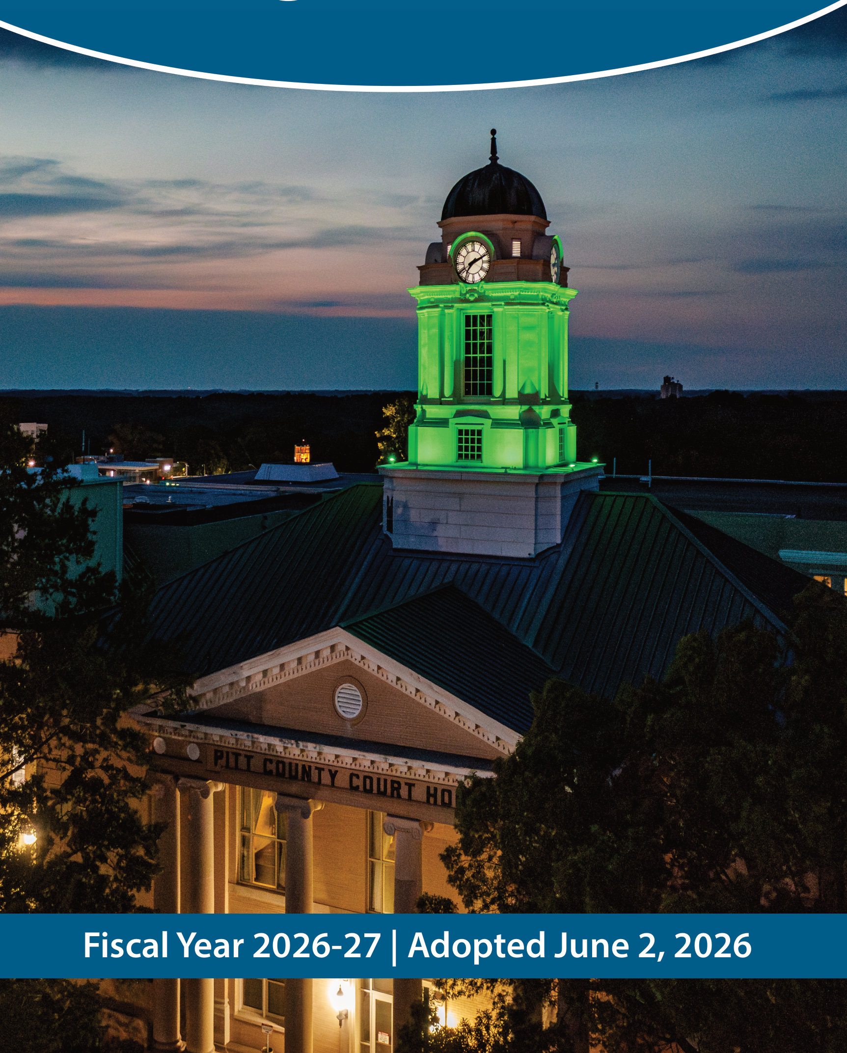 Pitt County Courthouse illuminated in green at dusk