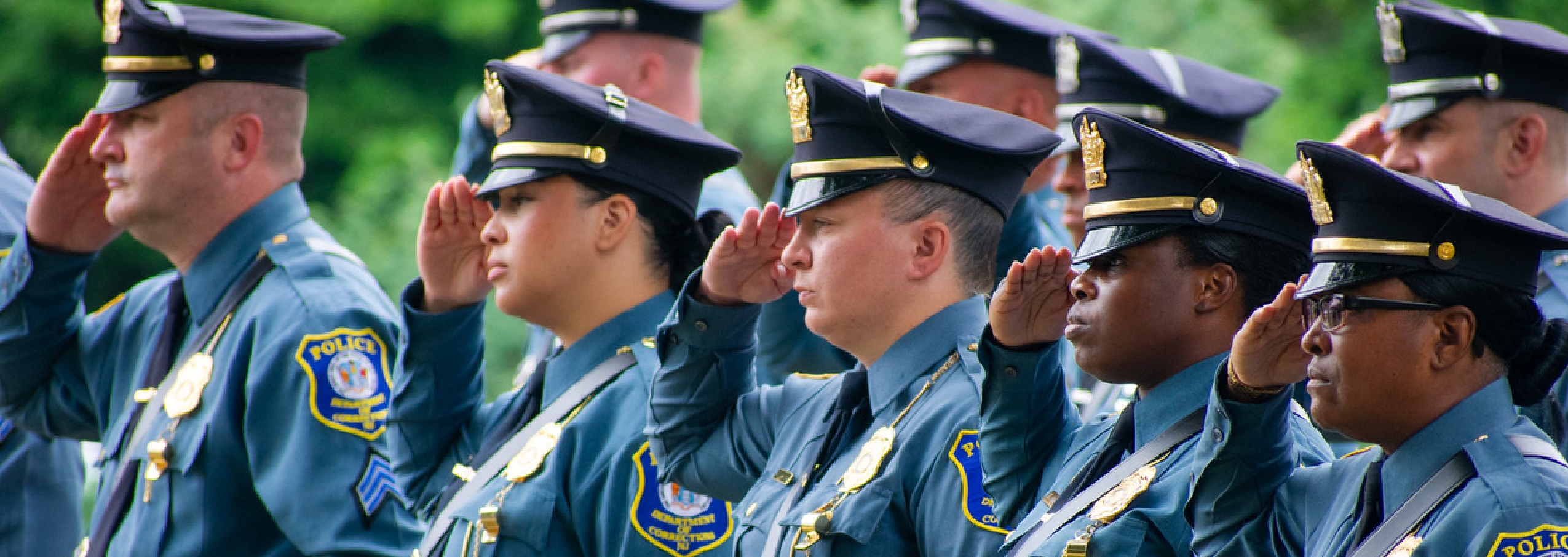 Row of New Jersey Department of Corrections correctional police officers in dress uniform saluting