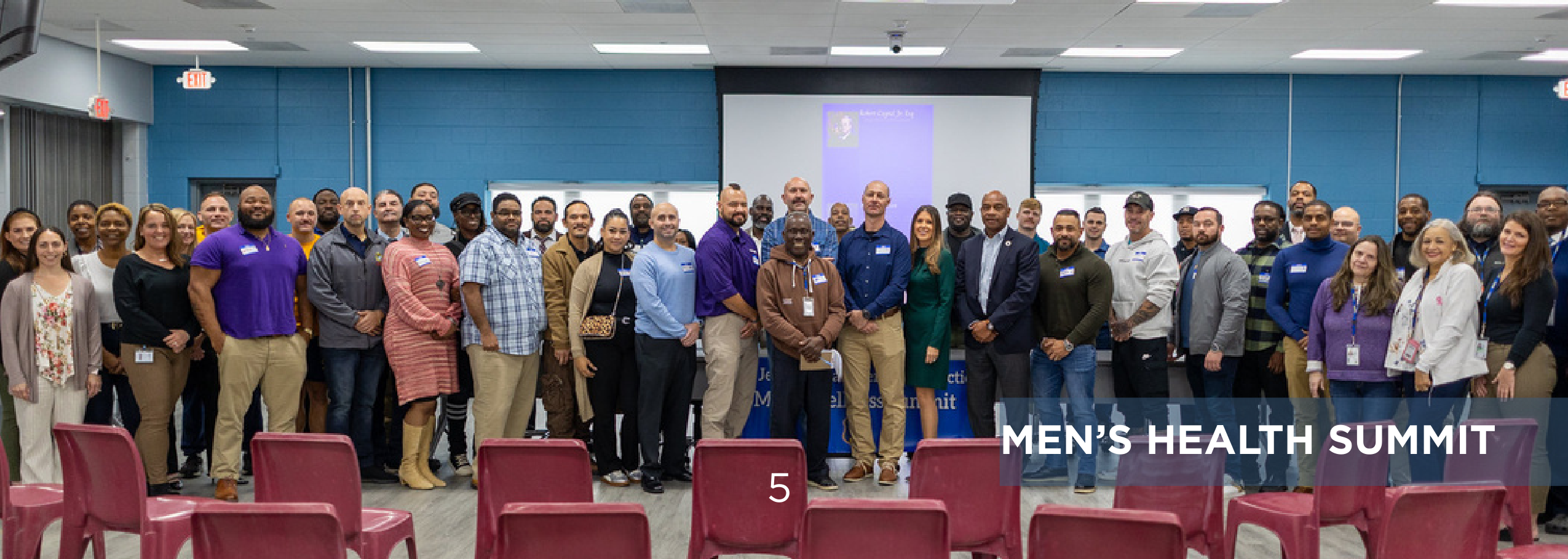 Group photo of attendees and staff gathered at the Men's Health Summit