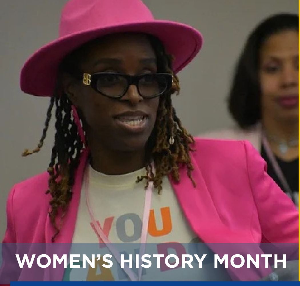 Women's History Month celebration attendee with pink hat and blazer