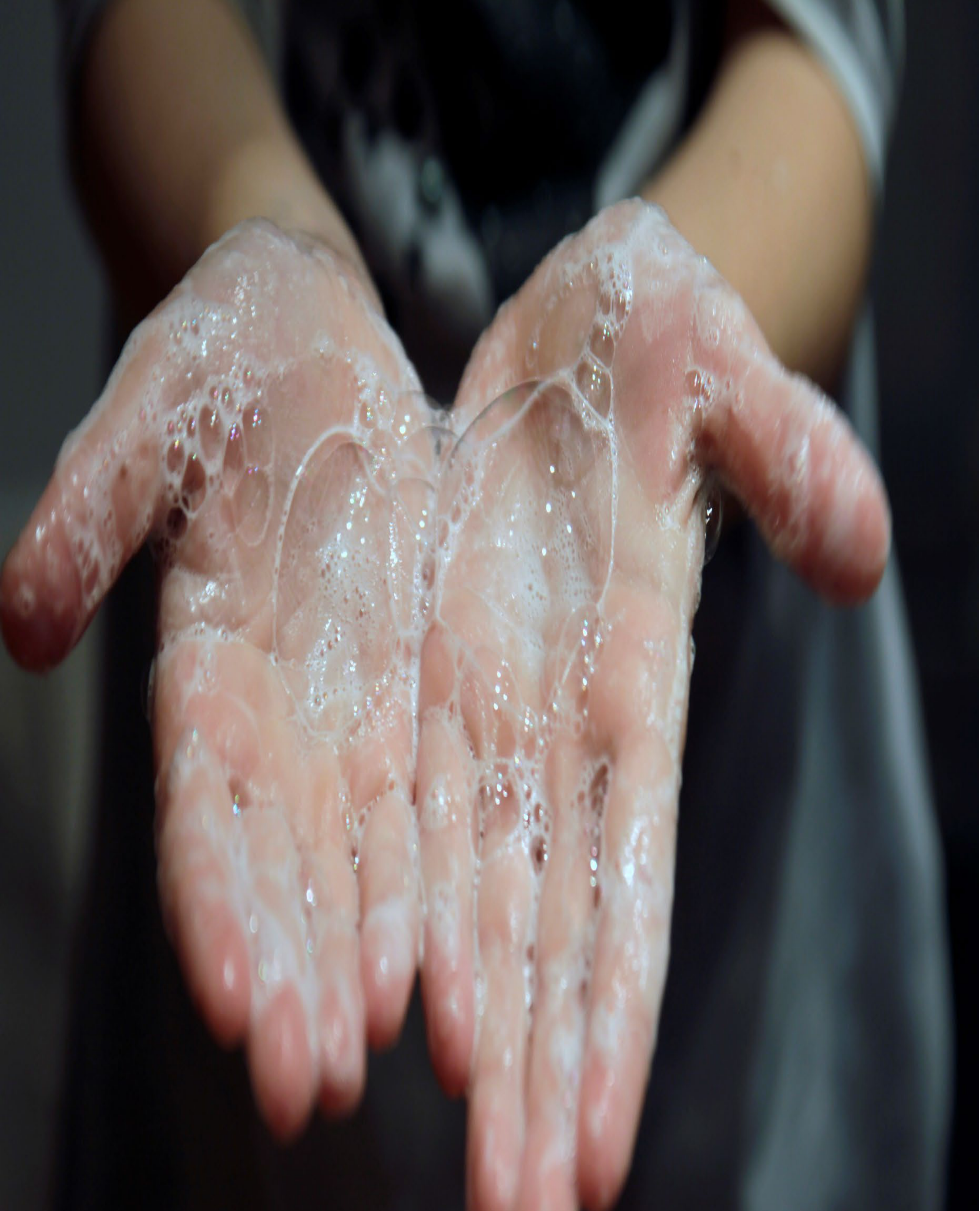 Child's soapy hands covered in bubbles