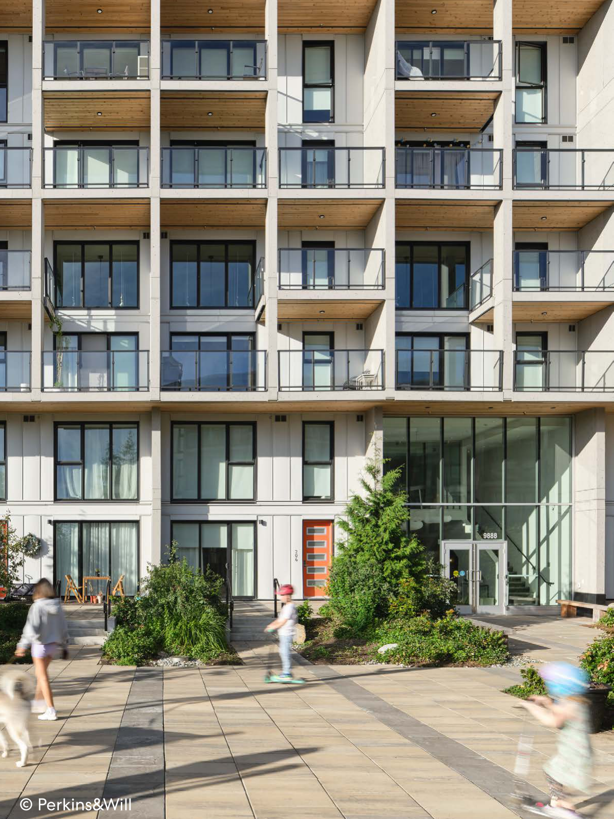 Multi-family apartment building with balconies and a landscaped public courtyard.