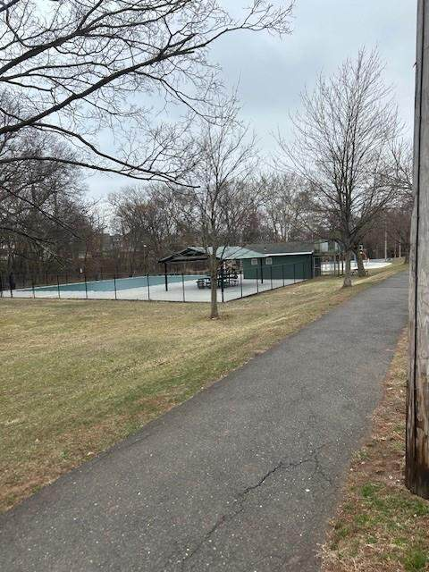 Paved pathway leading toward the Lepp pool facility and covered pavilion