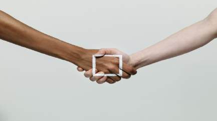 Two diverse hands shaking through a rectangular frame