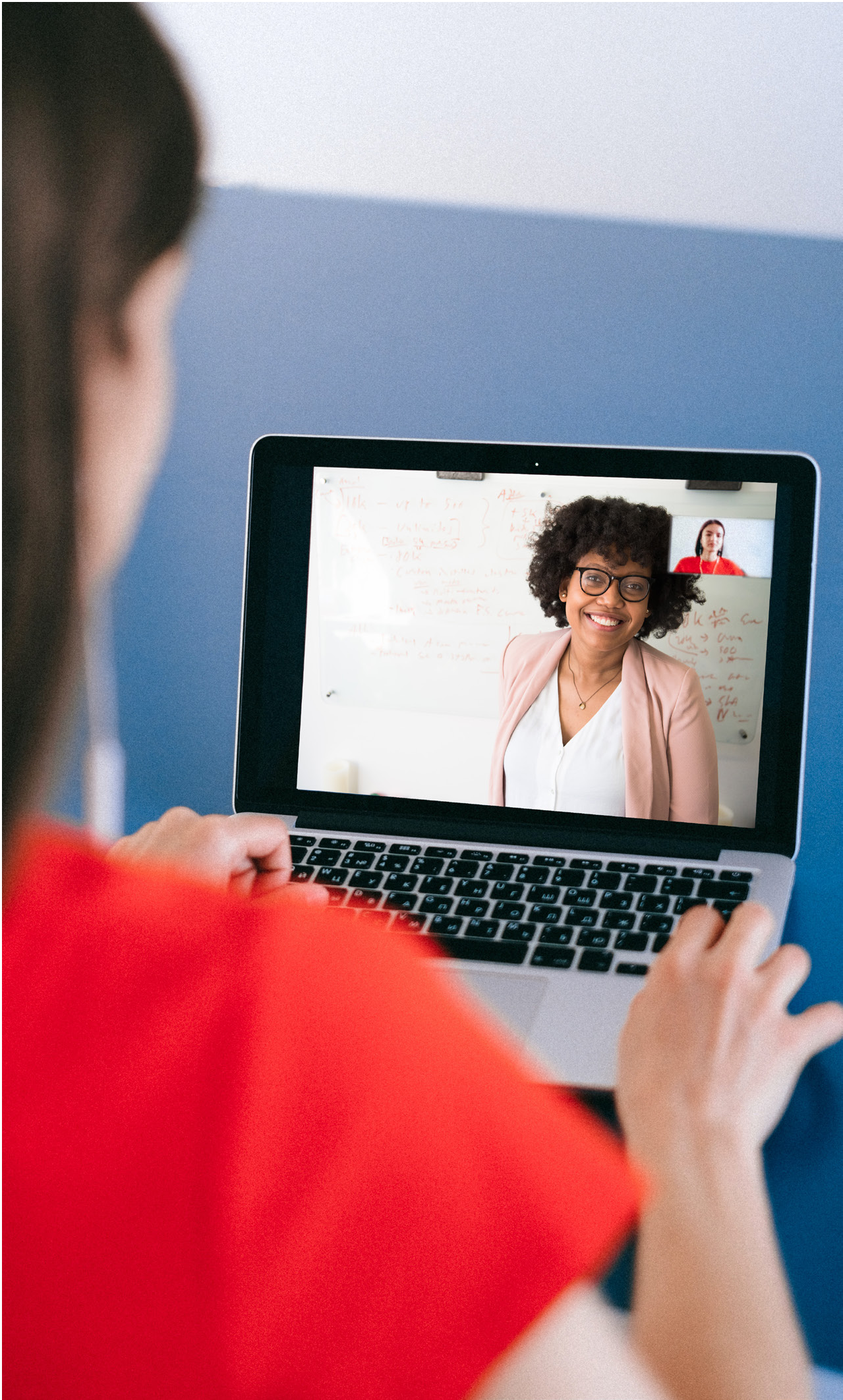 A person using a laptop for a video call with a health professional.