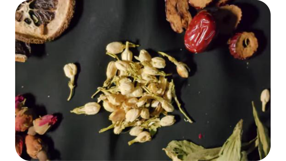 Top-down view of dried jasmine flower buds on a dark background