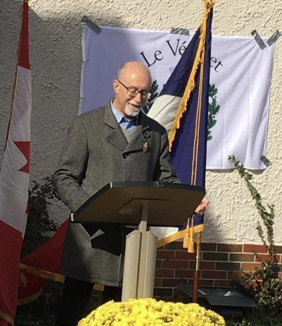 Guest speaker reading speech at podium