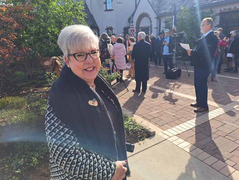 Attendee smiling outdoors at Mayor's Reception