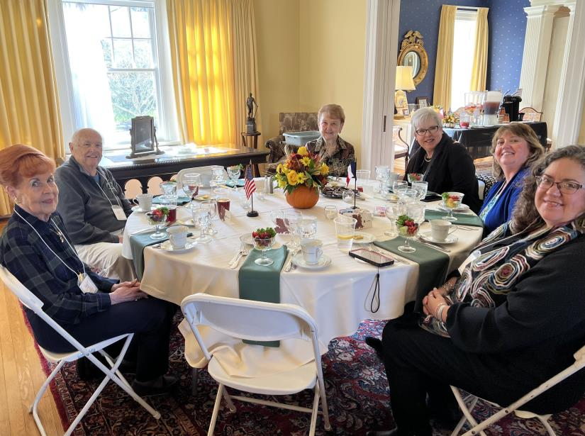 Guests at a dining table with fall pumpkin and flag decorations