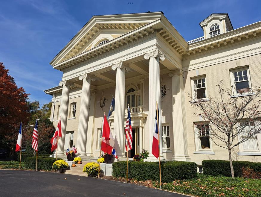 Exterior view of the historic Hawthorn Hill mansion with flags out front