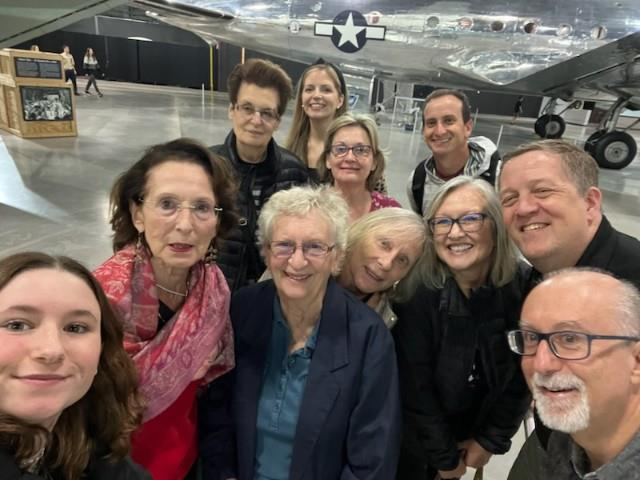 Group photo selfie in front of aircraft