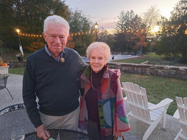 Couple posing outdoors during sunset