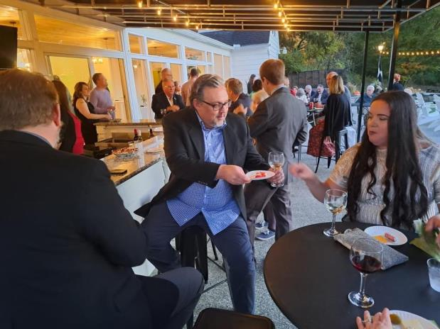 Guests socialising outdoors at high tables