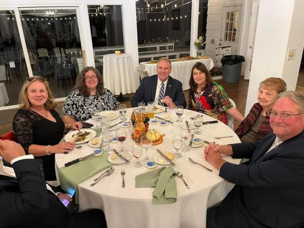 Guests seated at a round table enjoying dinner