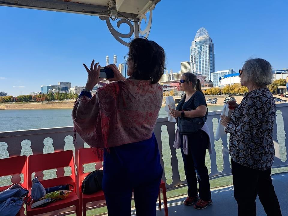 Passengers taking photos of Cincinnati skyline from the deck