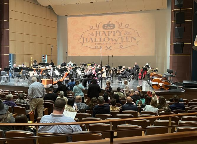 Stage view with Happy Halloween screen banner and orchestra setup