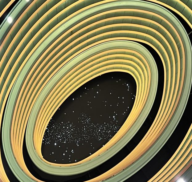 Architectural view looking up at the concentric oval illuminated ceiling structure