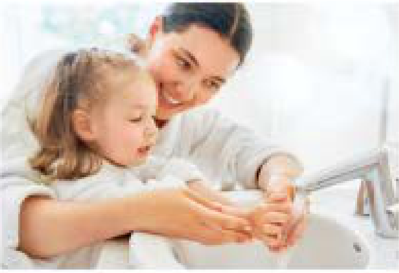 Mother and child washing hands at a sink