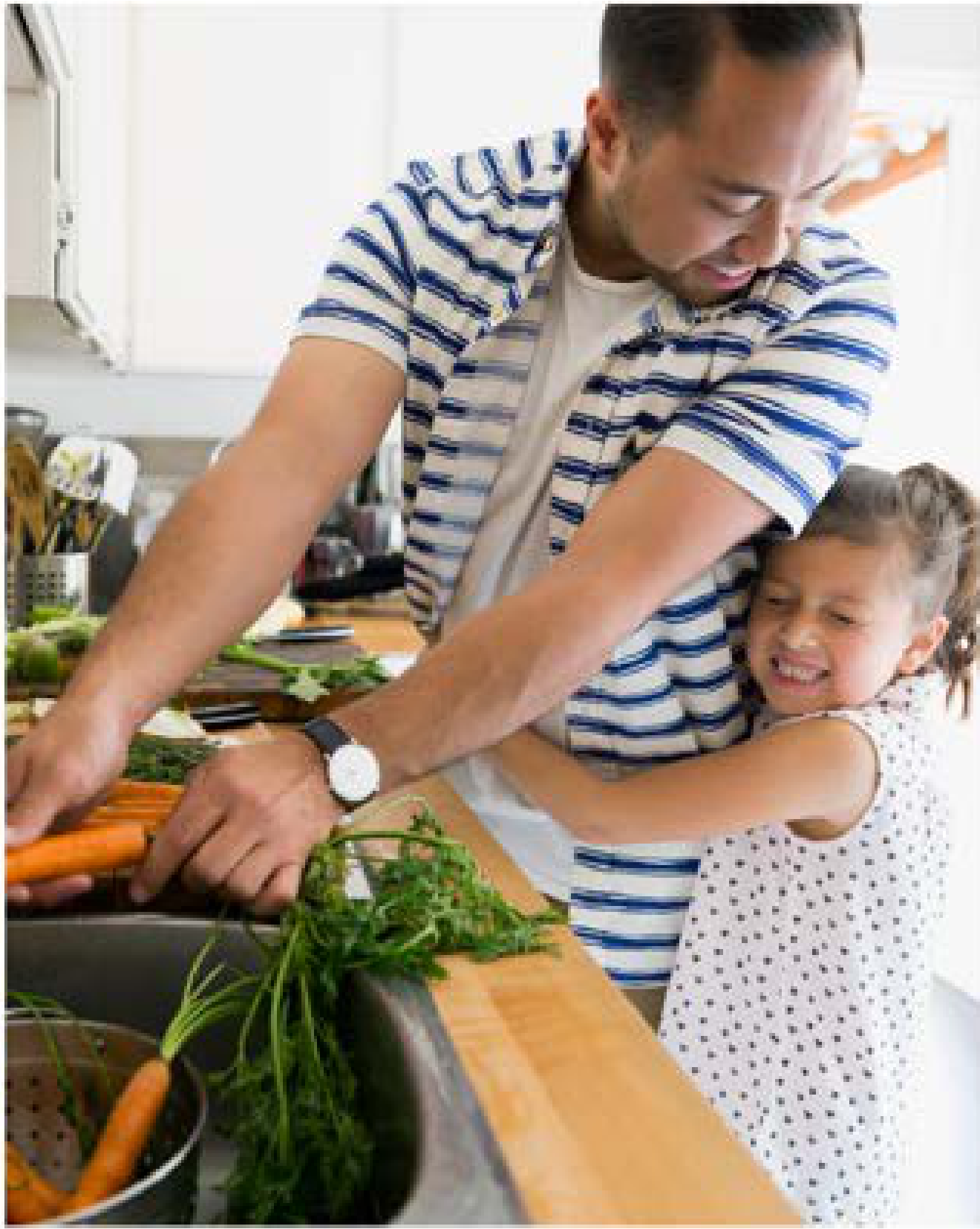 Father and daughter preparing vegetables in kitchen sink