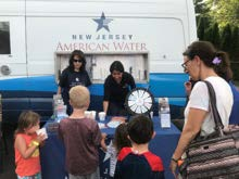New Jersey American Water community engagement vehicle and team interacting with families