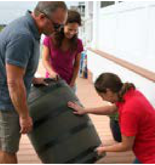 Volunteers assembling a rain barrel during a community workshop