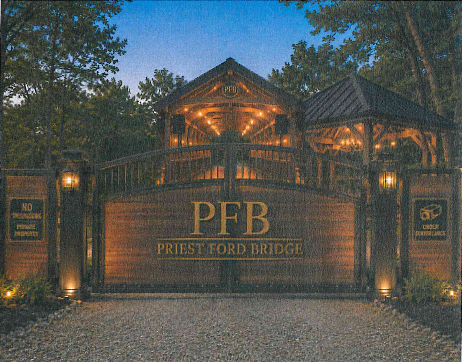 Completed entrance concept rendering at dusk for Priest Ford Bridge showing illuminated wooden covered bridge structure with central gate bearing 'PFB PRIEST FORD BRIDGE' lettering