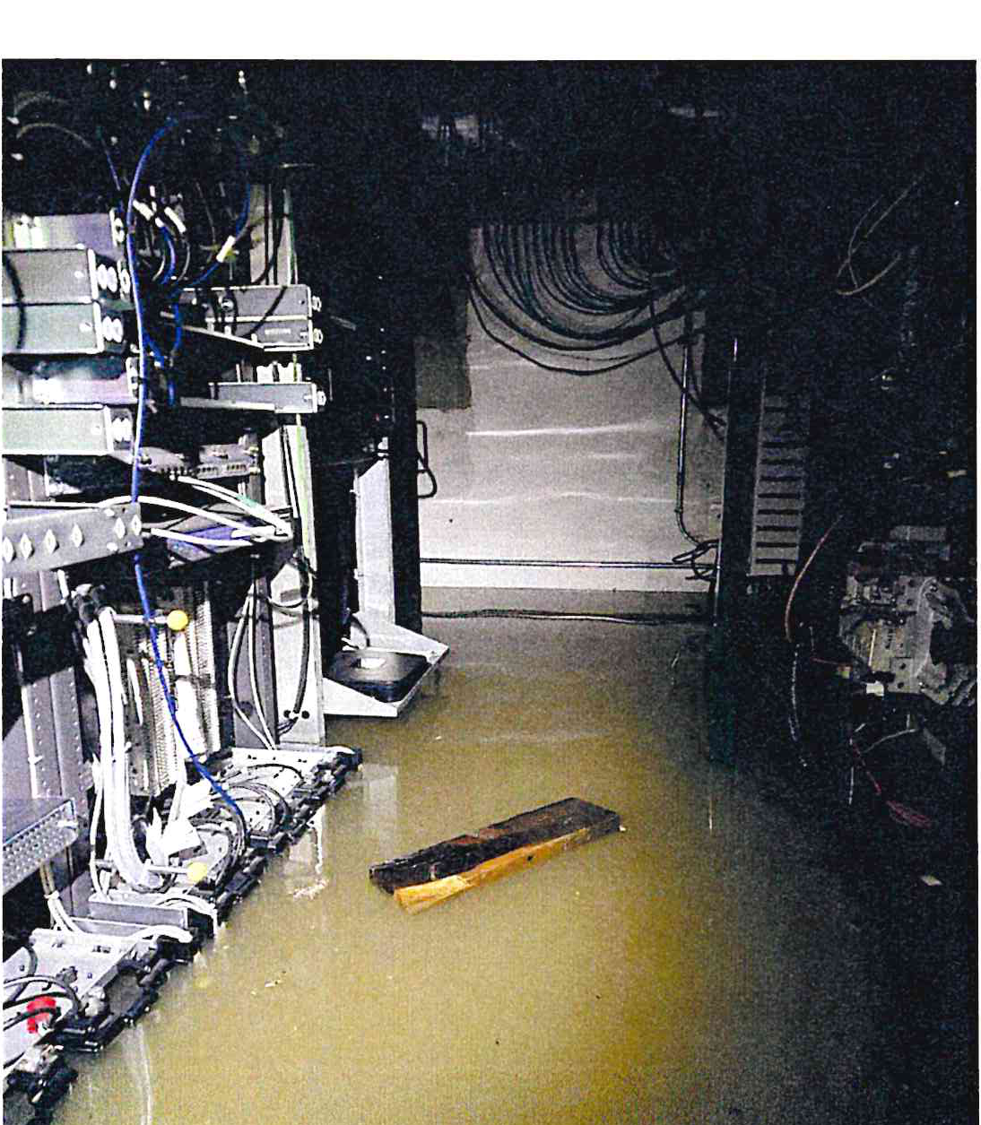 Floodwater inundating the floor and lower sections of electronic equipment racks at the Sampson Avenue communications facility.