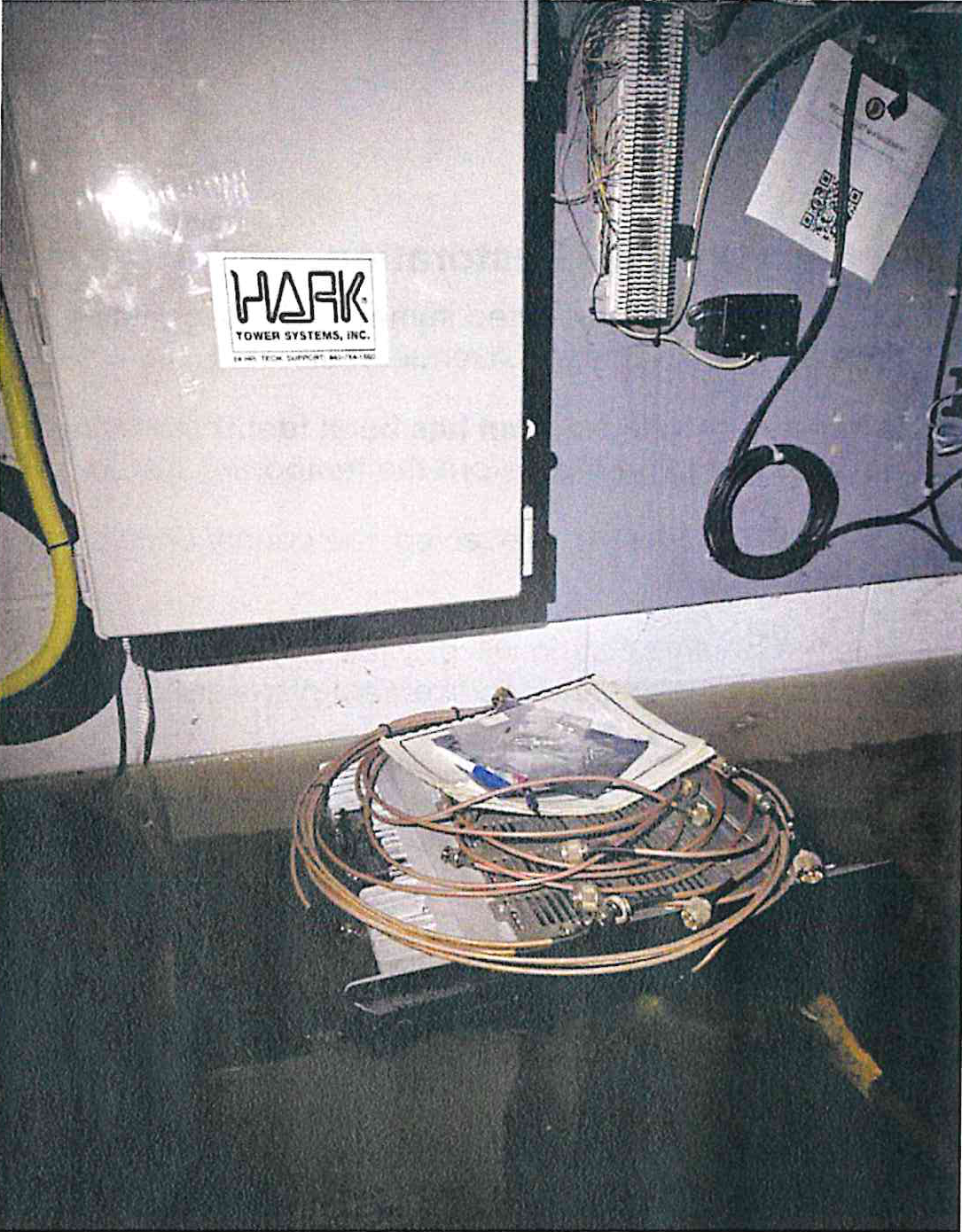 Flooded facility interior showing electrical panels and electronic equipment surrounded by standing floodwater