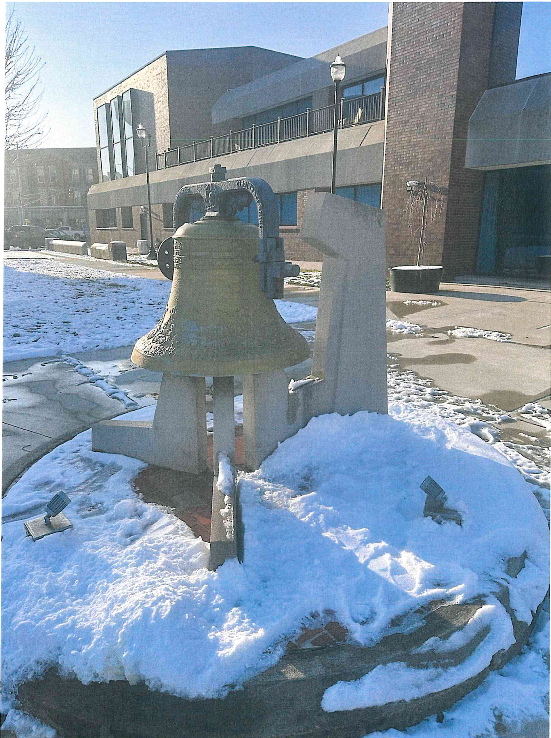 Photograph taken February 2026 of the existing bell monument in front of the building during winter