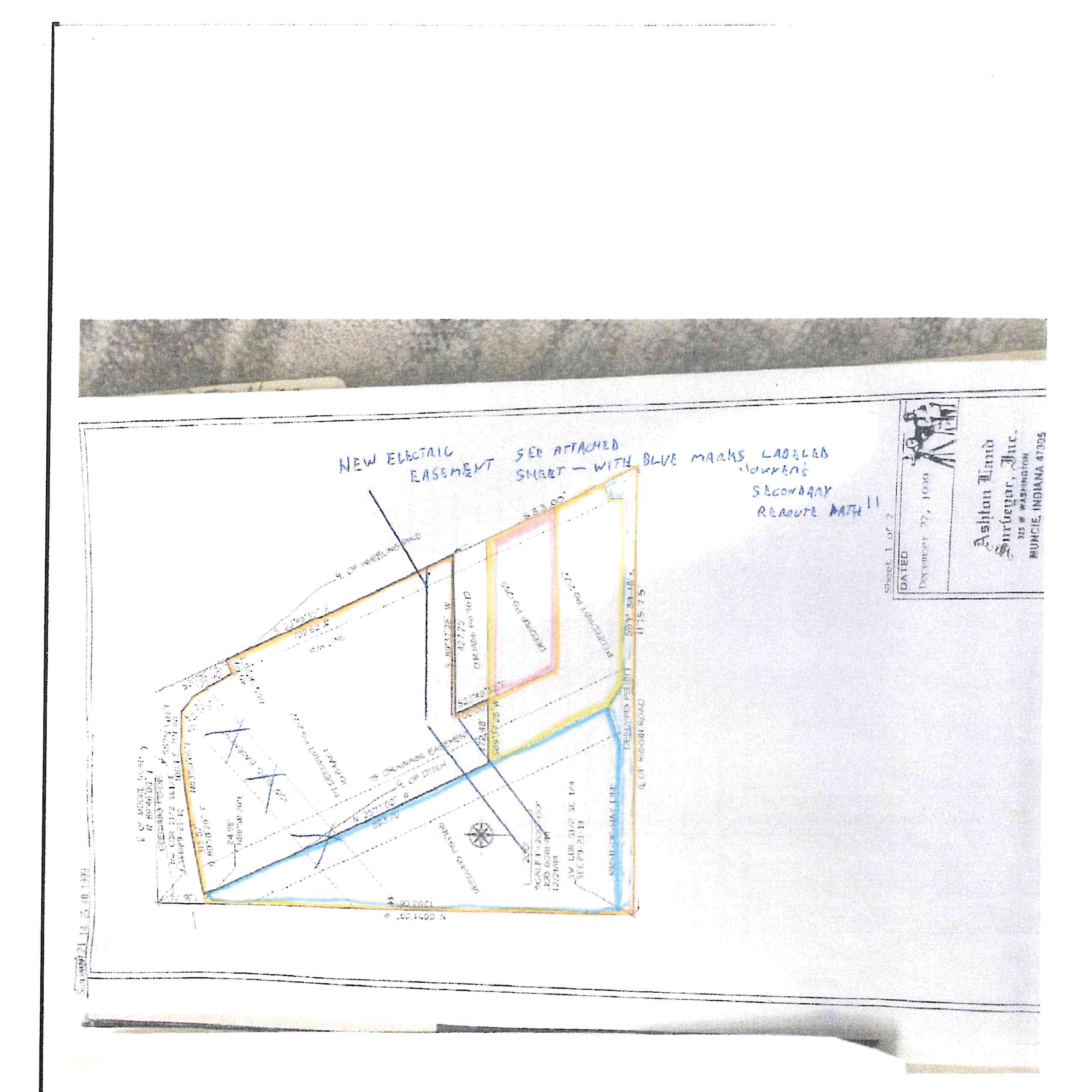 Boundary survey drawing prepared by Ashton Land Surveyor, Inc. for Job 6011-99, showing property boundary lines along Riggin Road and Wheeling Pike, a 15-foot drainage easement, ditch centerline, parcel deed references, and handwritten notes indicating a new electric easement and Journey's secondary reroute path.