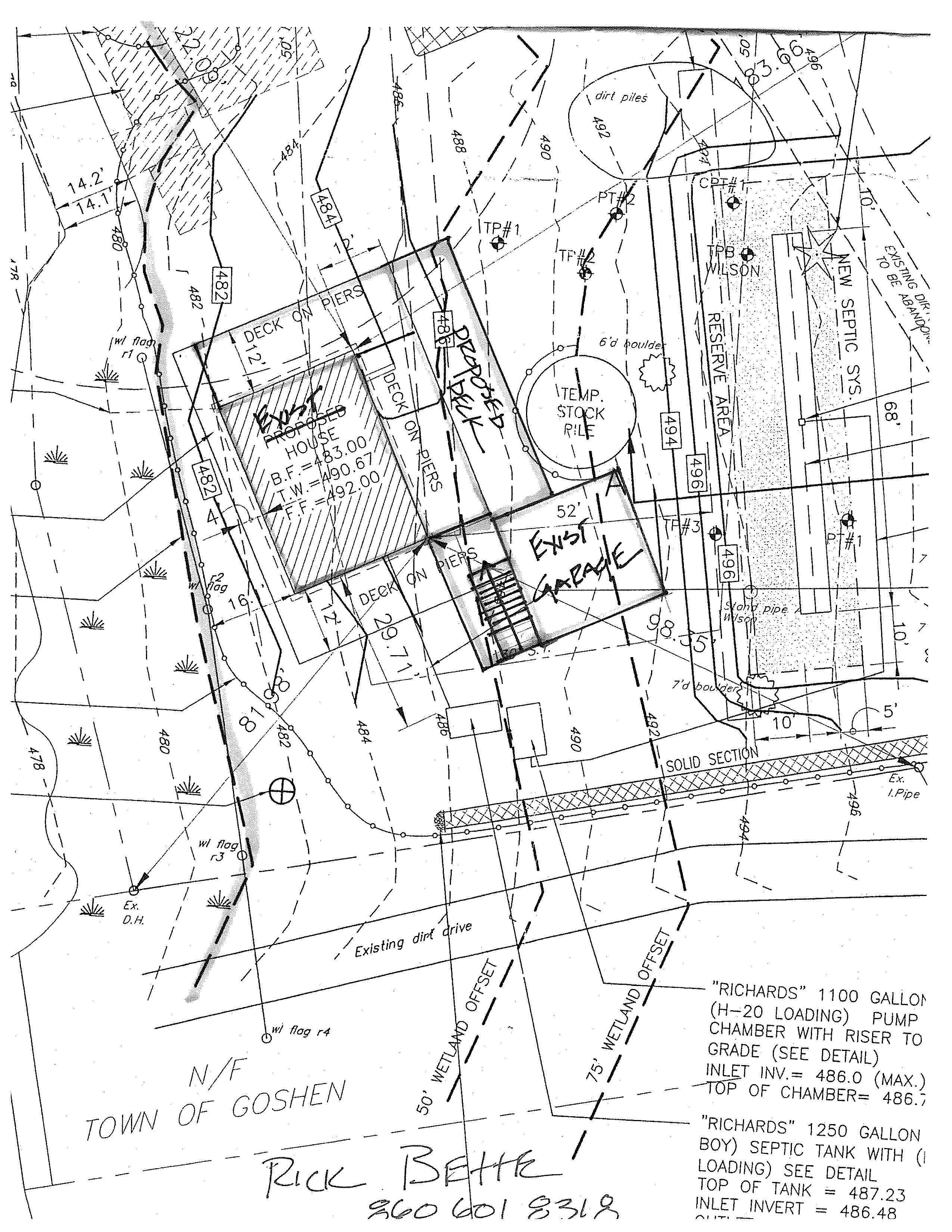 Full engineering site-plan sheet showing the proposed house and decks at center-left, the existing garage below it, the reserve area and new septic system at right, wetland offset lines and flags, property boundaries, contours, and the existing dirt drive along the lower portion.